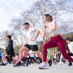 Group of adults in a fitness class outdoors in İstiklal Park, İstanbul.